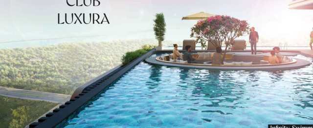 Infinity swimming pool overlooking the treeline at Rajapushpa Casa Luxura, Neopolis, Kokapet