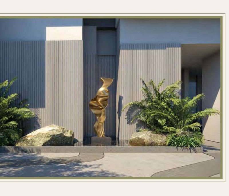 The sculptural kinetic art installation at the Myscape Palma drop-off court, framed by boulders and tropical planting