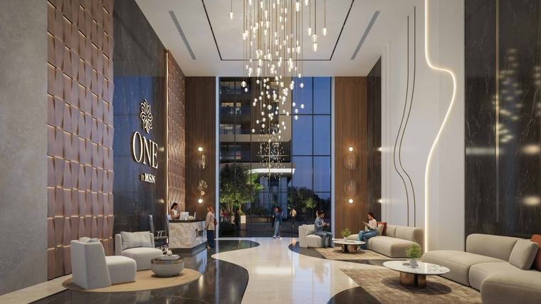 Double-height tower lobby at One by MSN with reception desk and seating, Neopolis