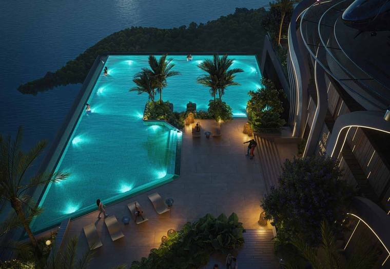 The sky infinity pool at One by MSN, lit at night above Neopolis