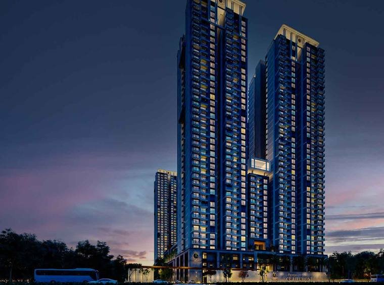 Prestige Clairemont towers illuminated at dusk above the entrance forecourt