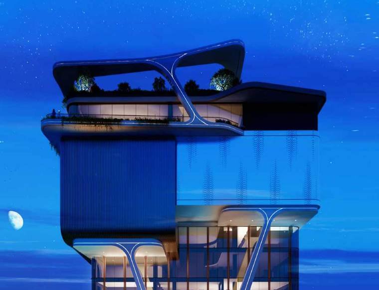 The G+6, 60,000 sq.ft clubhouse building at Rajapushpa Skyra, Neopolis, lit at night.