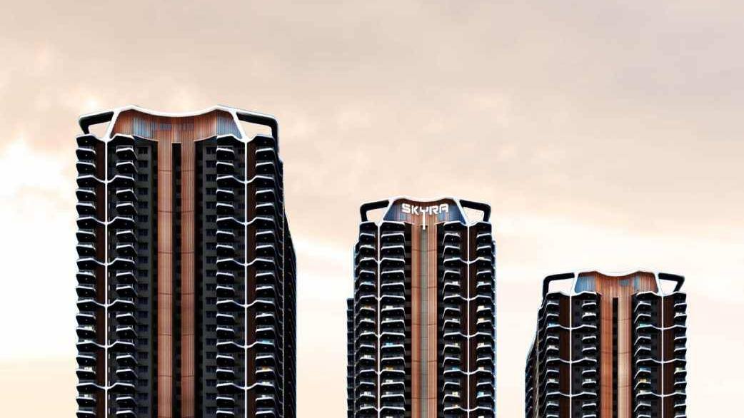 The three towers of Rajapushpa Skyra at Neopolis, Kokapet, seen against a dusk sky with the crowns of Aura, Bella and Clara lit.