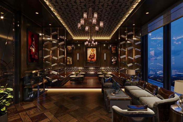 Cigar room with panelled walls and city views at Skyven Kokapet